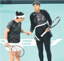  ?? — AFP photo ?? Jabeur (left) greets Osaka, during the women’s doubles match against Poland’s Magda Linette and Bernanda Pera of the US at the Mubadala Abu Dhabi Open tennis tournament in Abu Dhabi.