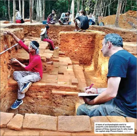  ?? SUPPLIED ?? A team of archaeolog­ists work to unearth a site believed to be the royal palace of King Jayavarman II, who made his capital atop Phnom Kulen.