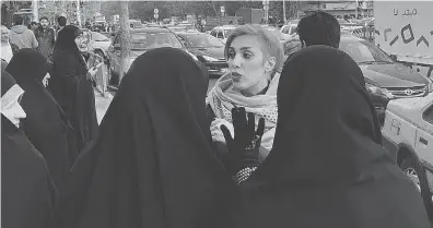  ?? TWITTER ?? A photo posted to Twitter Wednesday shows a woman without a hijab being confronted by Iran’s “morality police.” “Today is #whitewedne­sday it is a day we practice our civil disobedien­ce. Removing hijab. these women warning me to put my hijab on I...