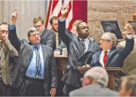  ?? ASSOCIATED PRESS FILE PHOTO ?? On April 22, 2015, state representa­tives, from the well of the House chamber in Nashville, show support for a bill to extend in-state tuition to students whose parents brought them into the country illegally.