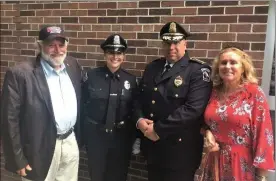  ??  ?? Evangeline Cakounes, second from left, was joined by her father and mother, Leo and Andrea Cakounes, and Orange Police Chief James Sullivan at her Fitchburg State University police academy graduation on Friday.