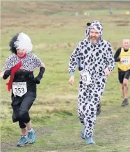  ??  ?? ●●Cruella De Vil and a pup put in an appearance at Bowstones Fell Race