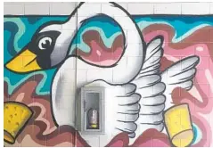  ?? JOY WALLACE DICKINSON ?? A Lake Eola swan looms large in a section of a mural by Orlando-area artist Johnny Coppersnak­e at the Thornton Park Central parking garage.