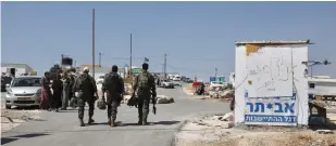  ?? (Marc Israel Sellem/The Jerusalem Post) ?? SOLDIERS ENTER the Evytar outpost on Monday.