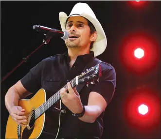  ?? Associated Press photo ?? In this June 2 file photo, Country music recording artist Brad Paisley performs at the graduation for Barrington High School, at Willow Creek Community Church in South Barrington, Ill.