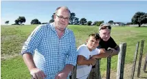  ??  ?? Fitzroy home owner Kristian Slack, George Slack, 10, and Craig Williamson are unhappy with the NPDC’s consultati­on document.