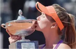  ??  ?? ROME: Elina Svitolina of Ukraine kisses the trophy after winning the WTA Tennis Open final against Simona Halep of Romania, on May 21, 2017 at the Foro Italico. —AFP