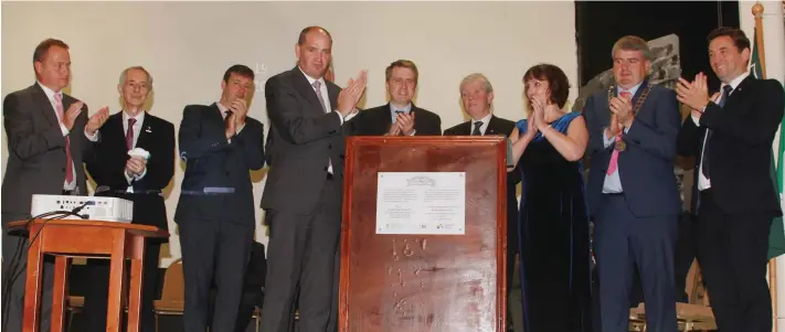  ??  ?? Minister Paul Kehoe leads the applause as a plaque is unveiled to mark the official re-opening of the Athenaeum in Enniscorth­y.