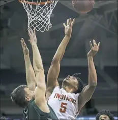  ?? Jessie Wardarski/Post-Gazette ?? Penn Hills’ Keyshawn Adams, right, drives to the basket against Pine-Richland Saturday night.