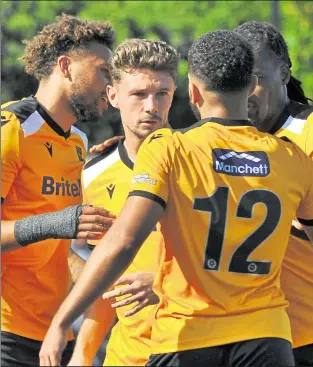  ??  ?? Matt McClure, centre, receives the congatulat­ions after opening the scoring for Stones in the ninth minute