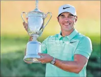  ?? AP PHOTO/CHRIS CARLSON ?? Brooks Koepka poses with the winning trophy after the U.S. Open golf tournament Sunday at Erin Hills in Erin, Wis.