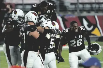  ?? ASSOCIATED PRESS ?? ARIZONA CARDINALS KICKER ZANE GONZALEZ (5) celebrates his game-winning field goal with teammates after an NFL game against the Seattle Seahawks on Sunday in Glendale. The Cardinals won 37-34 in overtime.