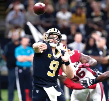  ?? Gerald Herbert/Associated Press ?? ■ New Orleans Saints quarterbac­k Drew Brees passes in the first half Sunday against the Arizona Cardinals in New Orleans. Brees passed for 373 yards and three touchdowns in his first game in more than five weeks after injuring his thumb.