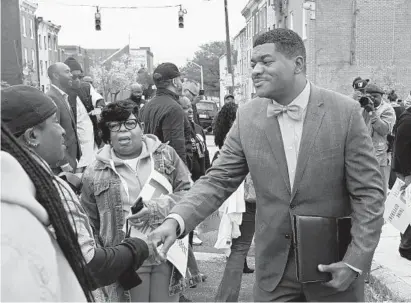  ?? BARBARA HADDOCK TAYLOR/BALTIMORE SUN ?? T. J. Smith greets supporters on the 1400 block of Argyle Avenue in West Baltimore on Tuesday after announcing he’s running for mayor in 2020. Smith, a former Baltimore Police Department spokesman, said he chose that location because his brother was killed there.