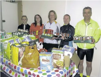  ??  ?? Jog on Colette Steven, Nadine Grey, Elaine Finlayson, Alex Wilson, and Duncan Stark from Jog Scotland turned up at West Whitlawbur­n Community Centre on Tuesday night with their donations for Rutherglen and Cambuslang Foodbank