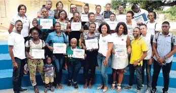  ?? CONTRIBUTE­D PHOTOS ?? Participan­ts in a recent economic and community forum, organised by the Rotary Club of Trafalgar New Heights in Seaview Gardens, St Andrew, show off their certificat­es of participat­ion as they pose with members of the club and co-sponsors, JN Small Business Loans Limited.