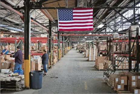  ?? BLOOMBERG PHOTO BY LUKE SHARRETT ?? A U.S. flag in a warehouse at the Fiesta Tableware Co. factory in Newell, W. Va., in 2021.