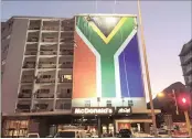  ??  ?? ILLEGAL: The SA flag adorns the building in Cape Town where a Zuma Must Fall banner was taken down by ANC supporters.