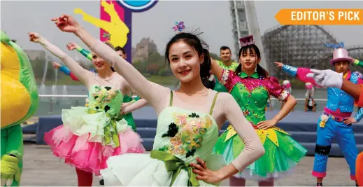  ??  ?? Performers dance at Shanghai Happy Valley. The park is to hold a magic festival on October 1-7. — Ti Gong