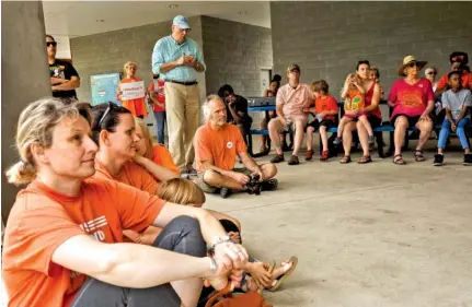  ?? STAFF PHOTOS BY DOUG STRICKLAND ?? People listen to a speaker during a Gun Violence Awareness Day event Saturday organized by Moms Demand Action.