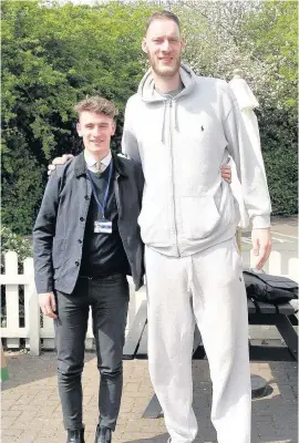  ??  ?? Pictured is Echo reporter Liam Coleman (left) with Paul Sturgess who is now Britain’s tallest man.