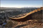  ?? BRYAN DENTON / THE NEW YORK TIMES ?? Tall steel beams in rows make up a border wall in Nogales. Mexico. President Donald Trump has vowed to shut down the government if Congress does not fund a wall on the southern border.