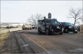  ?? JAMES MACPHERSON/ THE ASSOCIATED PRESS ?? Law enforcemen­t vehicles arrive Thursday at the closed Dakota Access pipeline protest camp near Cannon Ball, N.D. The camp was cleared of protesters, and 46 who defied the order to leave by Wednesday were arrested.