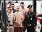  ?? NICOLAS ASFOURI /AFP ?? Suspects in the August 17 Erawan shrine bombing Bilal Mohammed (centre) and Yusufu Mieraili (back right) arrive at a military court in Bangkok on February 16.