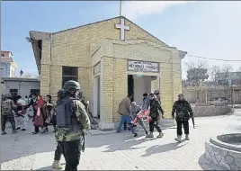  ?? AFP ?? Security personnel rescue a woman after the attack on Quetta’s Bethel Memorial Methodist Church.