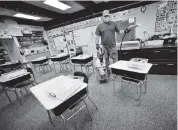  ?? KRISTOPHER RADDER The Brattlebor­o Reformer via AP ?? Dave Sheldon cleans a classroom Thursday at Dover Elementary School in Dover. Vt.
