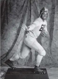  ?? John Leyba, Denver Post ?? Rashaan Salaam playfully poses as a Heisman Trophy, which he won in 1994, during a photo shoot prior to the announceme­nt of the winner.