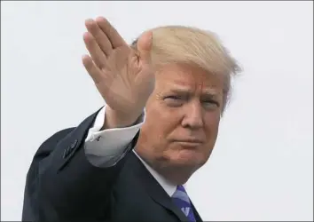  ?? Alex Brandon/Associated Press ?? President Donald Trump waves Thursday as he boards Air Force One before his departure from Joint Base Andrews, Md., to his Mar-a-Largo resort in Florida.