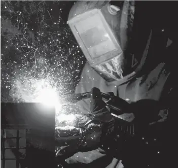  ?? CP PHOTO ?? A welder fabricates a steel structure at an iron works facility in Ottawa in March.