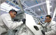  ??  ?? Assembling a VW Golf at a plant in Puebla, Mexico