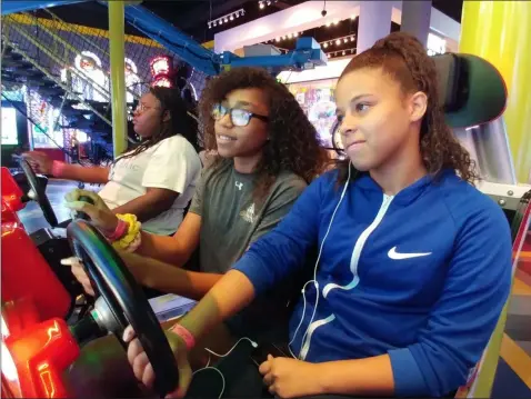  ?? ZACHARY SRNIS —THE MORNING JOURNAL ?? Boys and Girls Clubs of Lorain County members Jila Harvey, 15, left, Daijah Smith, 14, and Tatyanna Hale, 14, all Elyria residents, play a racing game Aug. 1 at Main Event in Avon.