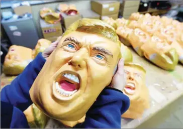  ?? TOSHIFUMI KITAMURA/AFP ?? An employee displays a rubber mask of US president-elect Donald Trump at the Ogawa Studios mask factory in Saitama, north of Tokyo.