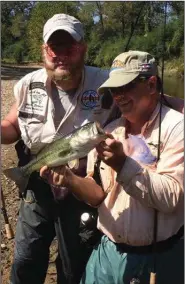  ?? (Arkansas Democrat-Gazette) ?? Shane Goodner (left) and the author inspect one of the 71 bass caught while fishing with Joe Volpe of Little Rock on Wednesday on the South Fork of the Ouachita River.