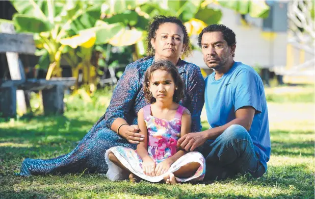  ?? Picture: ALIX SWEENEY ?? FAITH: Eli Napatali, with wife Olive and daughter Shanice, 8, received an electric shock on a navy ship in Cairns and is partially blind as a result.