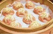  ??  ?? Din Tai Fung’s pork-filled soup dumplings are exquisitel­y crafted.