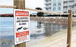  ?? AP FILE ?? The Walt Disney World Resort installed this sign and released this photo after the alligator attack on the beach outside the Grand Floridian hotel killed a 2-year-old Nebraska boy.