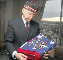  ?? JIM WELLS ?? Col. (Ret.) John Fletcher, a former Calgary Highlander, displays medals bestowed on his friend, American war hero Dr. David Bershad.