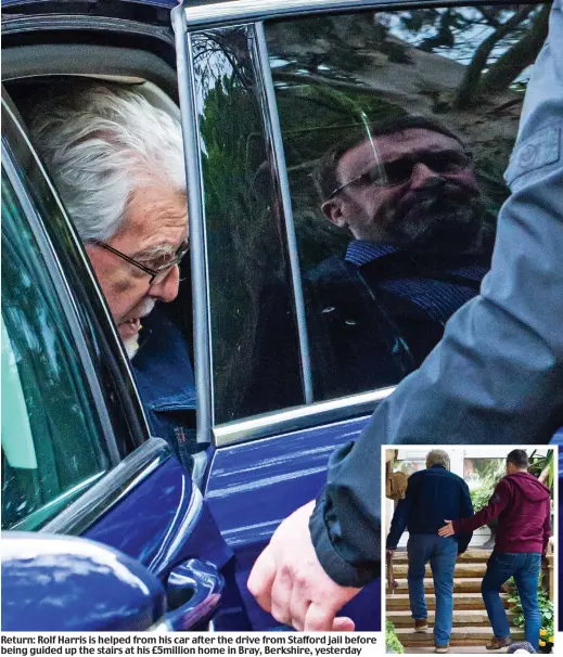  ??  ?? Return: Rolf Harris is helped from his car after the drive from Stafford jail before being guided up the stairs at his £5million home in Bray, Berkshire, yesterday