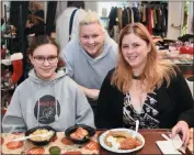  ?? JESI YOST — FOR MEDIANEWS GROUP ?? Helena Swiderski, 14, Marisa Swiderski, and Audra Ross prepare to sample some of the homemade food at Holy Trinity Orthodox Church.