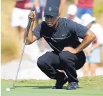  ?? LYNNE SLADKY/ASSOCIATED PRESS ?? Tiger Woods lines up a putt on the first hole during the first round of the Hero World Challenge. It was his first competitio­n in 466 days.