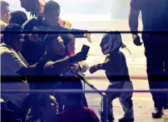  ??  ?? Microman greets supporters during a fight at the Arena Mexico.