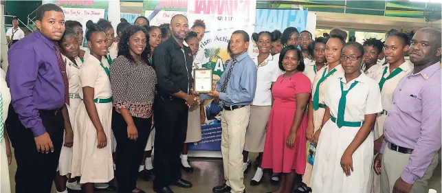  ?? CONTRIBUTE­D PHOTOS ?? Deanroy Bromfield (right), principal, Excelsior High School, and members of the school’s Tourism Action Club, receive the appreciati­on plaque from Matthew Blake (left), librarian, Jamaica Tourist Board.