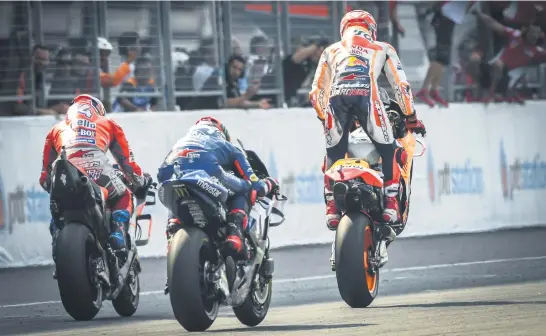  ?? Picture: AFP ?? STANDING TALL. Marc Marquez celebrates winning the Thailand Grand Prix in Buriram yesterday. He is followed by Andrea Dovizioso and Maverick Vinales.