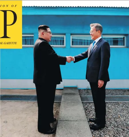  ?? KOREA SUMMIT PRESS POOL / AFP / GETTY IMAGES ?? North Korean leader Kim Jong Un, left, shakes hands with South Korea’s President Moon Jae-in at the Military Demarcatio­n Line that divides their countries ahead of their summit at the truce village of Panmunjom on Friday.