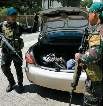  ??  ?? Des soldats philippins inspectent un véhicule appartenan­t à des résidents de Marawi qui tentent de fuir cette ville, où se déroulent des affronteme­nts depuis mardi.