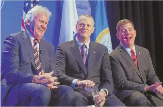  ?? STAFF FILE PHOTO BY NANCY LANE ?? SMILE SANDWICH: General Electric CEO Jeffrey Immelt, left, and Mayor Martin J. Walsh, right, chuckled as they flanked Gov. Charlie Baker at the 2016 announceme­nt of GE’s move to Boston. Campaign donations from GE execs have kept Walsh smiling.